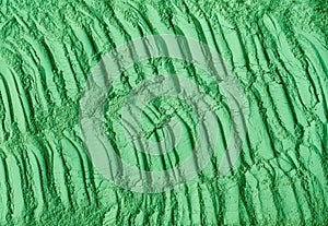 Green cosmetic clay powder kelp facial mask, spirulina body wrap texture close up, selective focus. Abstract background