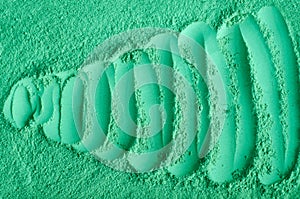 Green cosmetic clay powder kelp facial mask, spirulina body wrap texture close up, selective focus. Abstract background