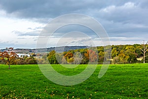 Green countryside field in cloudy day