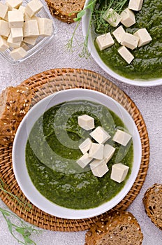 Green cream soup with slices of cheese