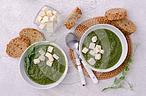 Green cream soup with slices of cheese