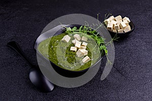 Green cream soup with slices of cheese