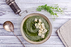 Green cream soup with slices of cheese