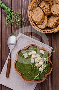 Green cream soup with slices of cheese