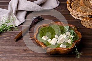 Green cream soup with slices of cheese