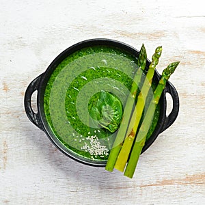 Green Cream soup with spinach and asparagus. Healthy food. Top view. Free space for your text