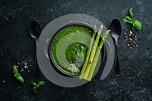 Green Cream soup with spinach and asparagus. Healthy food. Top view. Free space for your text