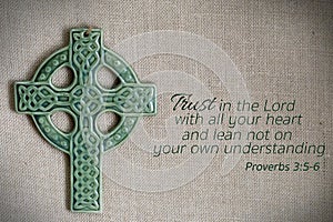 Green cross on burlap with proverb photo