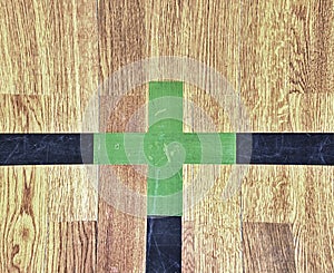 Green cross of lines. Shining floor of sports gymnasium