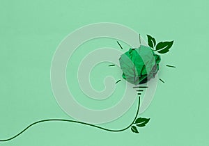 Green crumpled paper light bulb on green background, Corporate Social Responsibility CSR, eco-friendly business and