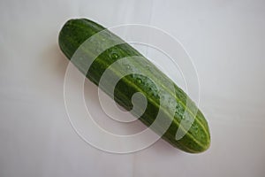 Green cucumber, fresh vegetables, kitchen background