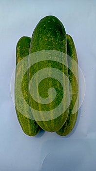 green cucumber with yellow spots isolated on white background.