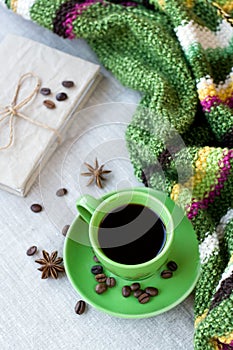 Green cup of coffee with coffee beans and anise