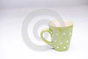 Green cup with dots. isolated
