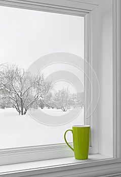 Green cup on a windowsill