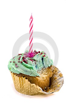 Green cupcake with candle and bite missing