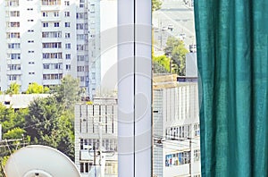 Green curtain on a decorative window with a photo of the street