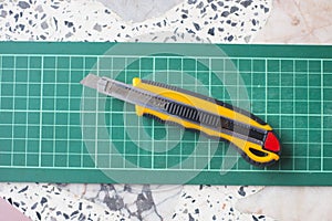 Green cutting mat with knife
