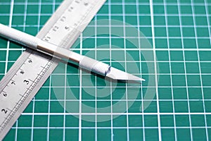 Green cutting mat and metal ruler