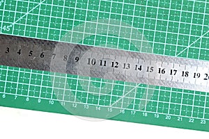 Green cutting mat with a ruler