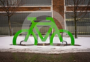 Green cycle installation marking a bicycle parking..