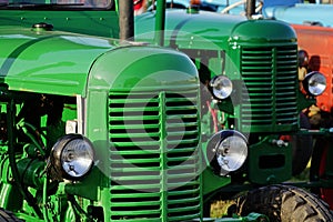 Green czechoslovak historical agricultural diesel tractors from 1950s displayed on expo.
