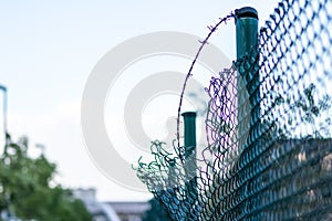 Green damaged wire-mesh fence is ruined after collision with car accident as crushed fence car insurance and property insurance