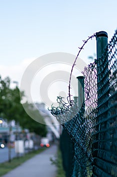 Green damaged wire-mesh fence is ruined after collision with car accident as crushed fence car insurance and property insurance