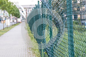 Green damaged wire-mesh fence is ruined after collision with car accident as crushed fence car insurance and property insurance