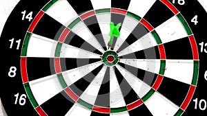 Green dart hitting the bullseye on white background