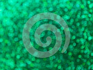 Green defocus lights background. Festive abstract bokeh