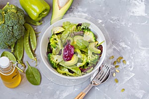 Green diet vegetable salad with peas, broccoli, avocado and pump