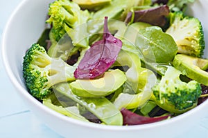 Green dietary vegetable salad with peas, broccoli, avocado and pump