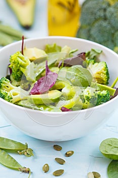 Green dietary vegetable salad with peas, broccoli, avocado and pump