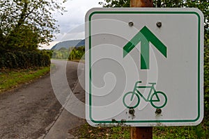 Green directional sign for bikers to ride straight on