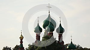 Green domes of Church with crosses. The roof of the church against the grey sky.