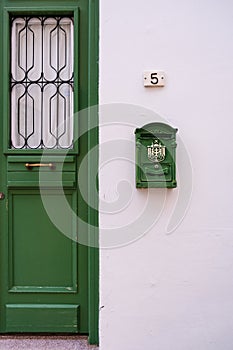 Green door and antique mailbox of a white traditional house in old Nicosia, Cyprus
