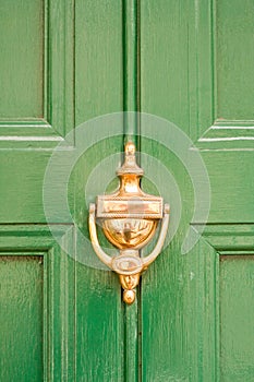 Green door with brass knocker