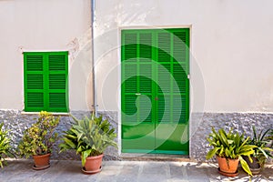 Green door and green window on old traditional house in Mallorca