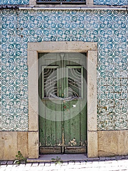 Green door in house with blue tiles in Beja, Portugal