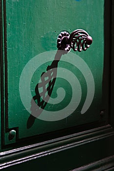 Green door with metal spiral handle