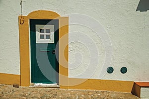 Green door on wall from a street of Evoramonte