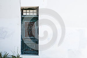 Green door in the white wall