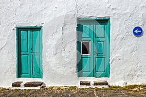 Green door and window on white wall