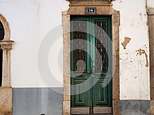 Green Door With Wrought Iron Decoration In Lisbon Portugal