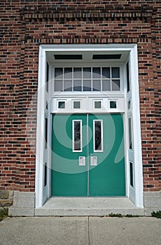 Green doors for a red brick building