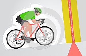 Green dressed cyclist riding upwards to finish line