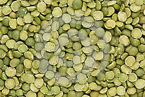 Green dry purified peas closeup top view background.