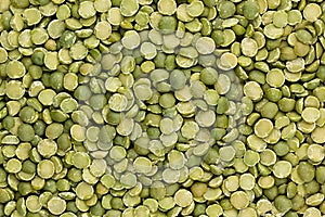 Green dry purified peas closeup top view background.