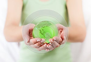 Green Earth Globe in Human Hands